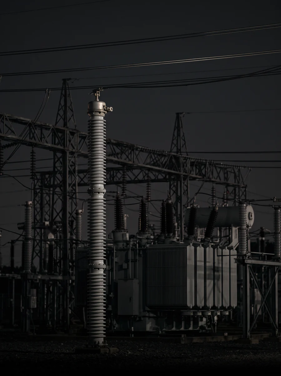 Illustration: a high-voltage substation at night.